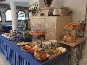 a table with a blue table cloth with food on it at Káptalan vendégház in Balatonalmádi