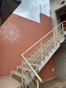 a staircase with a flower painted on the side of a building at Mandala Apartments 2 ambientes in Luque