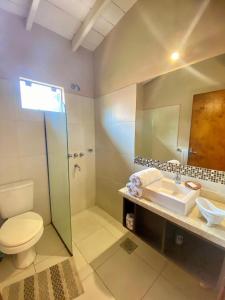 a bathroom with a shower and a toilet and a sink at Mandala Apartments 2 ambientes in Luque +38 photos