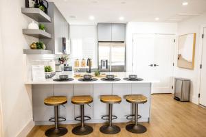 a kitchen with a counter with stools at The Sunset Cove in Wesley Chapel