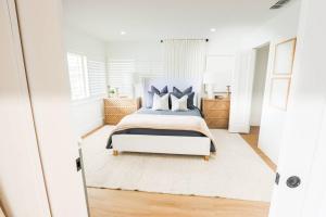 a bedroom with a king sized bed with blue accents at The Sunset Cove in Wesley Chapel