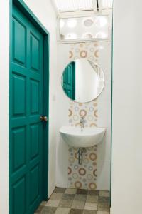 a bathroom with a green door and a sink at Summer Eternal Pool Villa Nimman in Chiang Mai