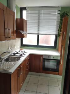 a kitchen with a sink and a stove and a window at Casa Marina in Sestu