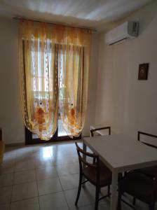 a dining room with a table and a window at Casa Marina in Sestu