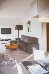 a living room with a couch and a table at Casa Ghjuvanna in Propriano