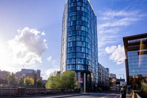 a tall glass building on a city street at City 2nd Floor Apartment in Midland