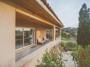 a balcony of a house with chairs and windows at Casa Ghjuvanna in Propriano