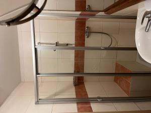 a bathroom with glass shelves and a sink at Ferienwohnungen Gruber in Rust