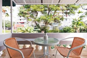 a table and chairs in front of a window at Summer Eternal Pool Villa Nimman in Chiang Mai