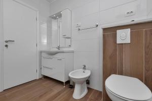 a white bathroom with a toilet and a sink at Villa Infinite Joy in Makarska +32 photos