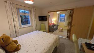 a bedroom with a teddy bear sitting on a bed at Willowdale B&B in Breakish