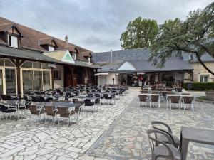 a group of tables and chairs on a patio at Le Dugny'tique, un endroit fantastique ! in Onzain