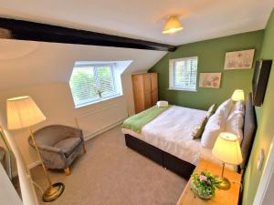 En eller flere senge i et værelse på Town Farm Cottage