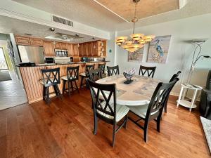 a kitchen and dining room with a table and chairs at Sand Dollar 3-304 in Saint Augustine +3 photos