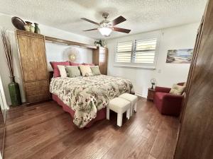 a bedroom with a bed and a ceiling fan at Sand Dollar 3-304 in Saint Augustine