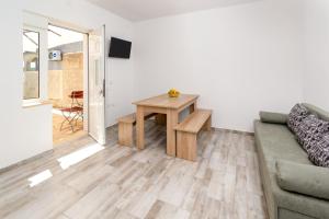 a living room with a couch and a table at Apartmani AJP Posedarje in Posedarje