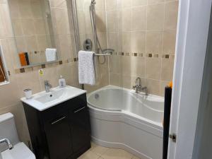 a bathroom with a tub and a sink and a toilet at Nelly's Nest in Bridlington +40 photos