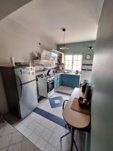 a kitchen with a refrigerator and a table in it at Host Patagonia - DPX in Plaza Huincul