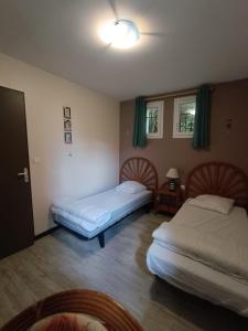 a room with two beds and a table with a lamp at appartement, résidence centre ville, Le Tréport in Le Tréport +15 photos