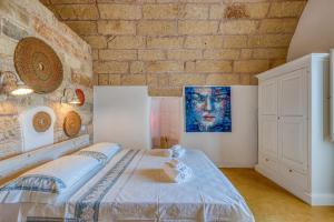Postel nebo postele na pokoji v ubytování Tenuta Palmira agriturismo