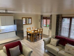 a kitchen and living room with a table and a dining room at Nelly's Nest in Bridlington