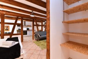 a room with a bed and a living room with wooden beams at Gite See You Soon - Studio Zen in Colmar