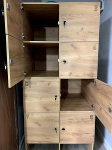 a wooden closet with wooden drawers at Safar in Karakol