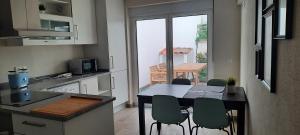 a kitchen with a table and chairs in a kitchen at Pura Vida Alentejo by Portus Alacer in Gavião