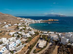 an aerial view of a town with white buildings and the ocean at ANETON Residences in Karavostasi