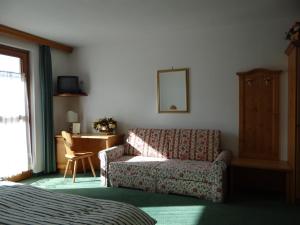 a living room with a couch and a table at Hotel Mondeval in Selva di Cadore