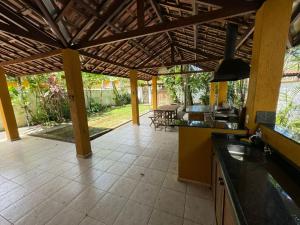 an open kitchen with a large open patio at Casa Amarela in São Sebastião