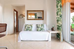 a bedroom with a white bed and a mirror at Luxury Apartment in Nikiti