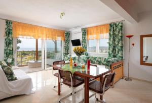 a living room with a glass table and chairs at Luxury Apartment in Nikiti