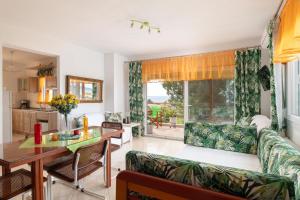 a living room with a couch and a table at Luxury Apartment in Nikiti