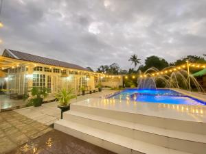 a resort with a swimming pool and a fountain at Benido Farm - A Secret Haven in San Jose