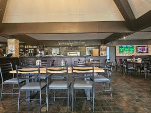 a restaurant with tables and chairs and a bar at Castle Home in Centurion