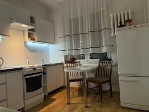 a kitchen with a small table and chairs in it at Mieszkanie Dla Turystów in Sandomierz