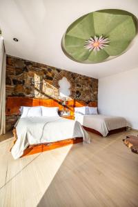 Postel nebo postele na pokoji v ubytování Hotel El Templo