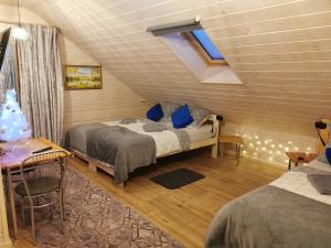 a bedroom with two beds and a table and a desk at Noclegi Święta Katarzyna ,, Pod Jeleniami "prawdziwymi in Święta Katarzyna +61 photos
