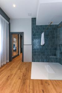 a living room with green tiles on the wall at La Casa Azul Boutique Hotel in Andújar