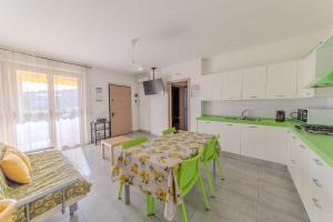 a kitchen with a table and a dining room at Your Sea Home - Marina di Campofilone in Pedaso