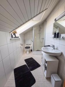 a bathroom with a sink and a toilet at Ferienwohnung Brigitte in Nördlingen