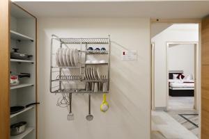 a kitchen with a shelf with utensils on a wall at Balaji Homestay - home with free Wi-Fi and parking in Varanasi