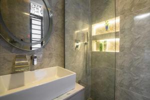 un bagno con lavandino, specchio e doccia di 247 Electricity 2 bedrooms Lux Ikate with PS5 opt a Lekki Altre 20 foto