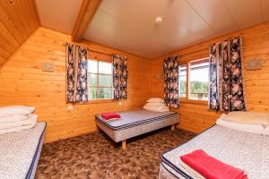 a room with two beds and two windows at Sokka Holiday Center & Glamping in Otepää