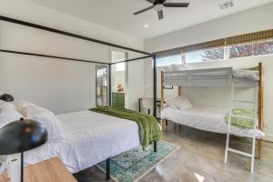 two bunk beds in a room with a window at Walk to Lake Home with Game Room in Medicine Park! in Medicine Park