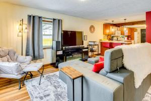 a living room with a couch and a tv at 1 Mi to IU Hoosier Home with Fire Pit and Fenced Yard in Bloomington