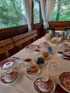 a table with plates of food on it at Agriturismo Al Respiro Nel Bosco in Camporotondo di Fiastrone +22 photos
