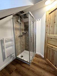 a shower stall in a room with a wooden floor at Am Hirtenturm, anno 1397, auf der Quelle der Ahr in Blankenheim