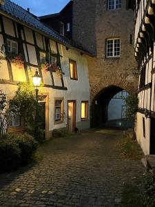 an alley way in an old building with a tunnel at Am Hirtenturm, anno 1397, auf der Quelle der Ahr in Blankenheim